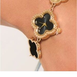 Elegant gold and black clover bracelet watch